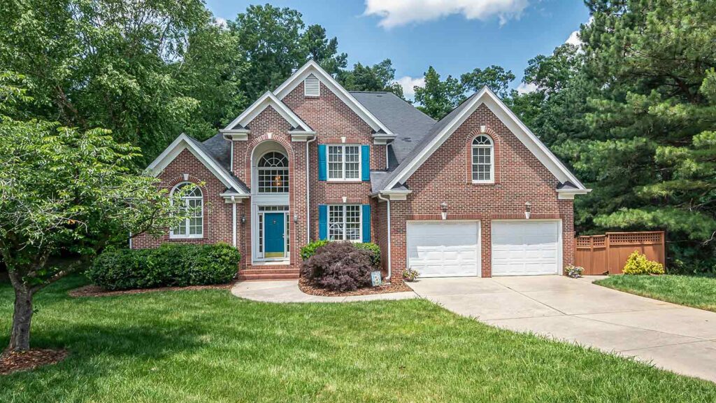 a brick house with a driveway and a lawn mortgage loan lenders mortgage lenders