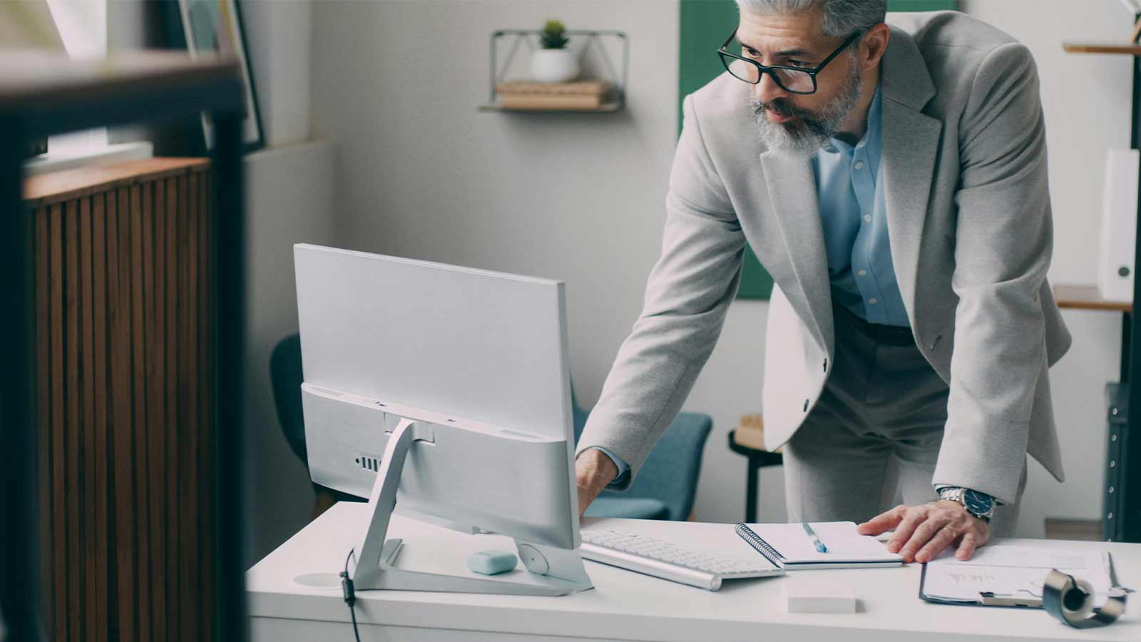 a man standing in front of a computer mortgage loan lenders mortgage lenders