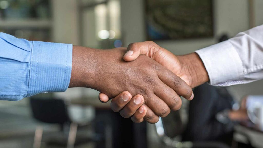 close-up of a handshake of a man and woman property deed abstract of title title abstractor