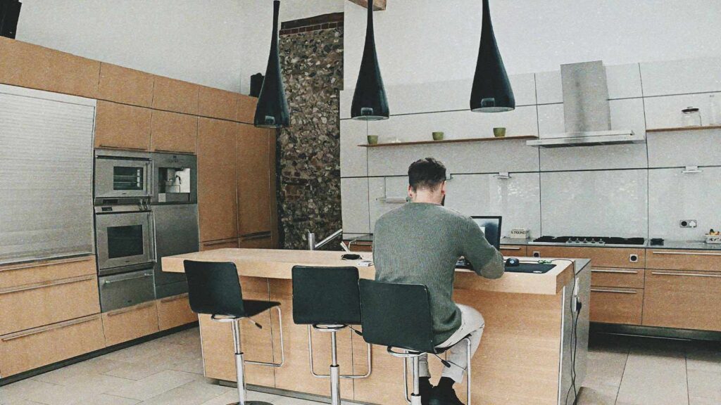 a man sitting at a table with a laptop mortgage lien lien release chain of title title search company title abstractor title search services mineral rights search title update
