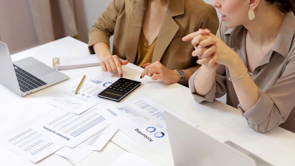 a woman pointing at a calculator webhooks