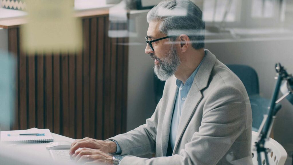 a man sitting at a desk using a computer API integrations