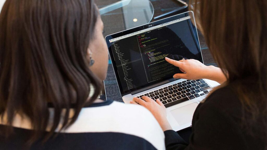 a woman pointing at a laptop screen API integrations
