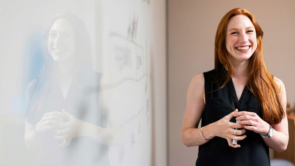 a woman standing in front of a whiteboard ECC algorithms