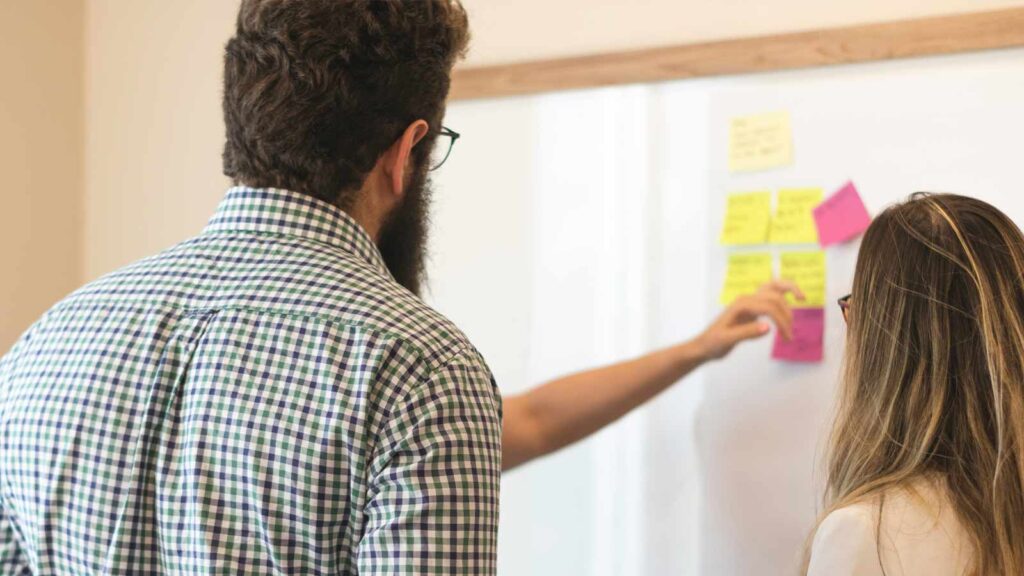 a man with a beard and a beard writing on a whiteboard AI-Powered Title Searches