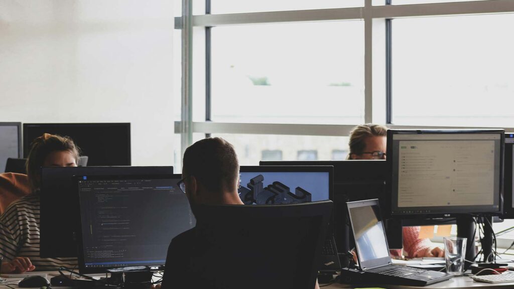 a group of people working on computers property deed