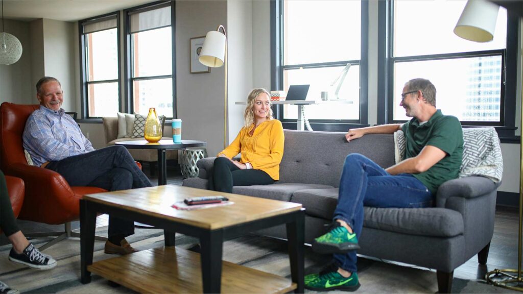 Casual conversation in modern living room. AI Title Search Platforms