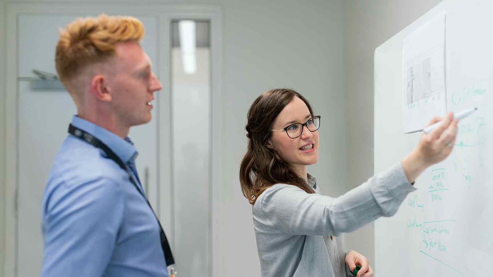 Person presenting ideas on whiteboard. Deed