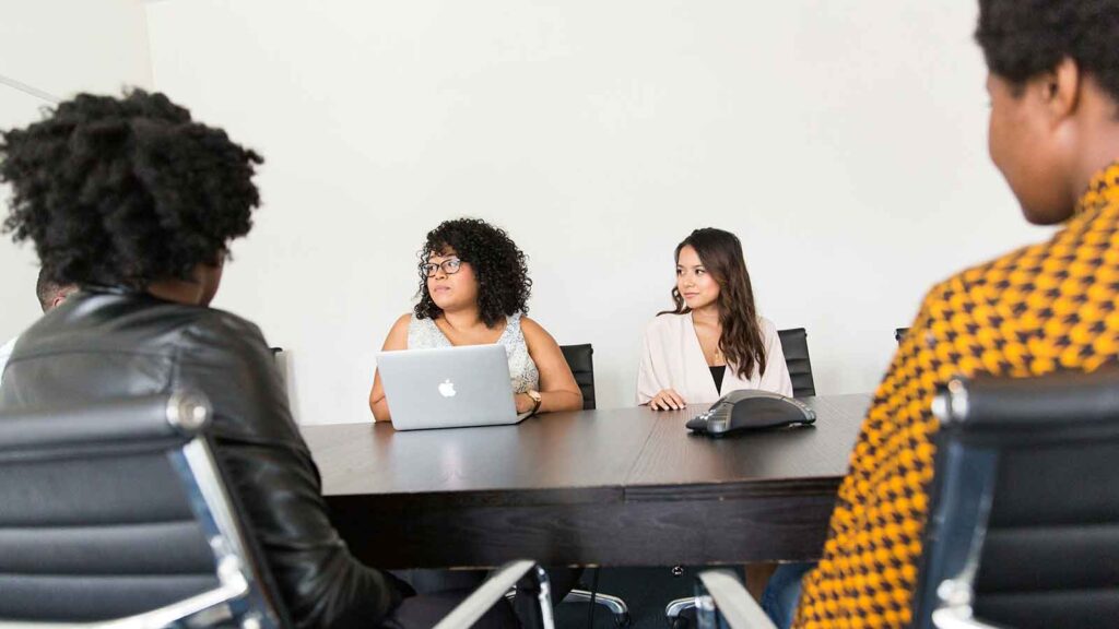 Group meeting around a conference table talking about Parcel Data