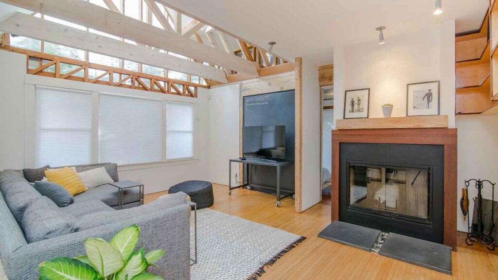Modern living room with fireplace and TV title search
