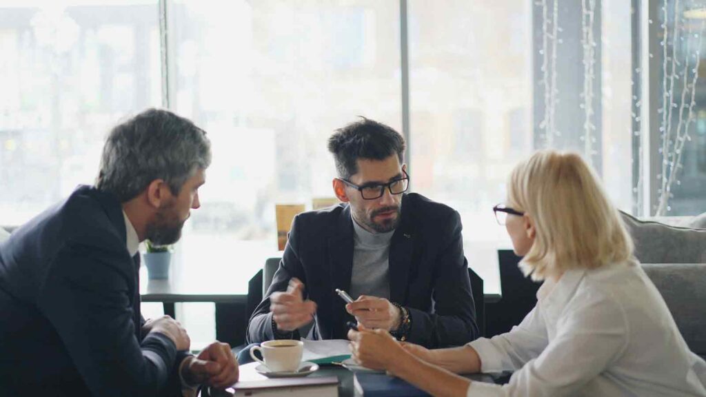 Three people engaged in discussion. Title Portal